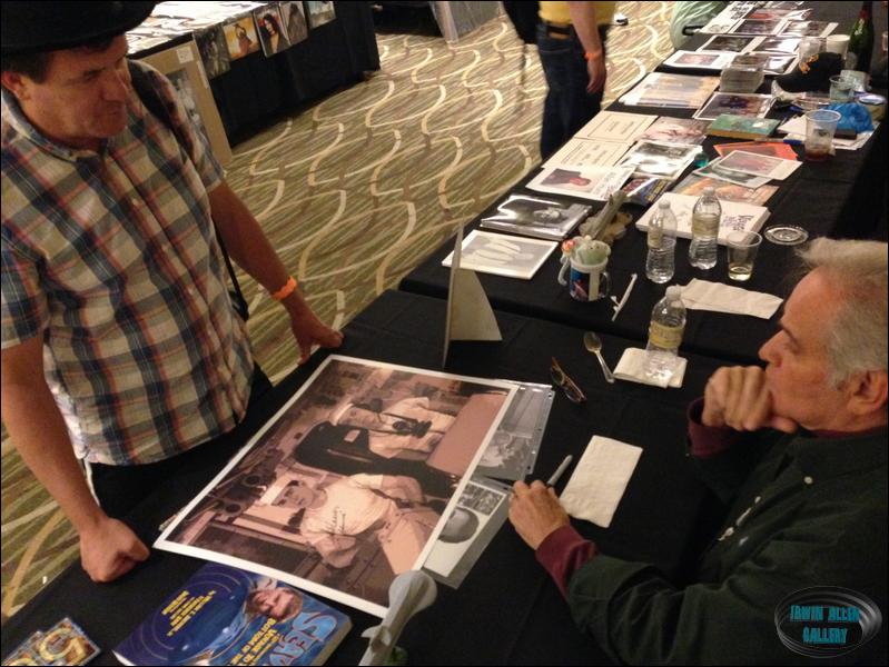 Derrik Lewis autographing a poster