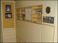 Stateroom With Bed and Desk Folded Up 