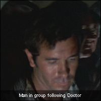 Man in group following Doctor